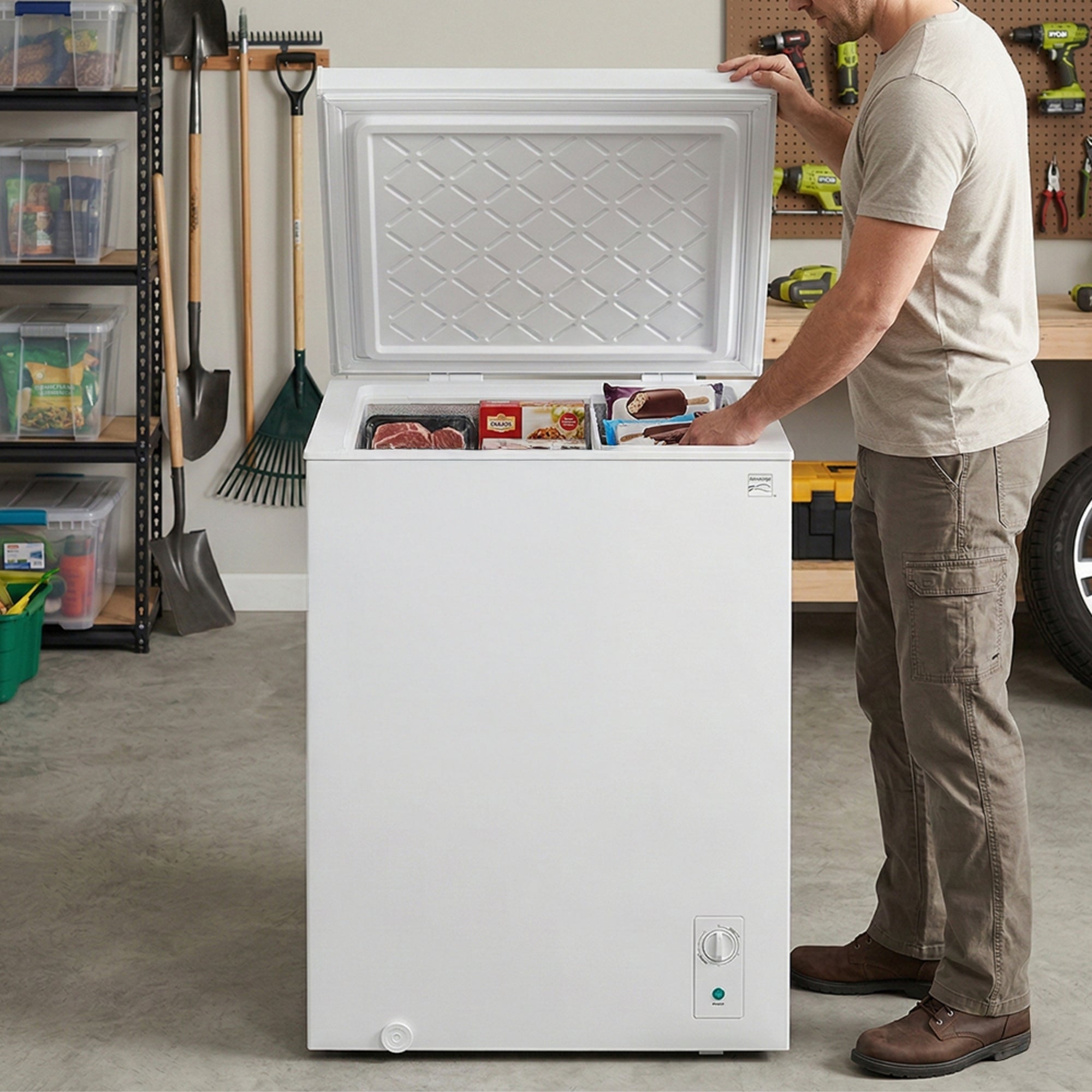 Kenmore convertible chest freezer, open, with a person placing food inside, in a garage