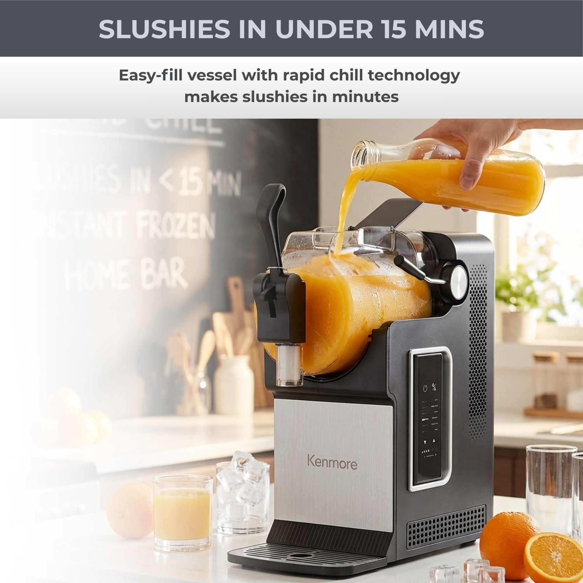 Kenmore slushie and frozen drink machine on a white counter with a chalkboard menu in the background and a person’s hand pouring orange juice from a glass bottle into the reservoir. Text above reads, “Slushies in under 15 mins. Easy-fill vessel with rapid chill technology makes slushies in minutes.”