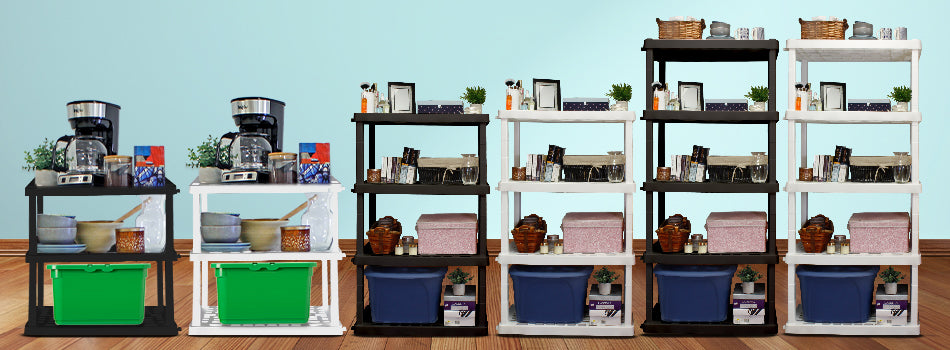 Three black and two white Oskar storage shelves on a wood floor in front of an aqua wall